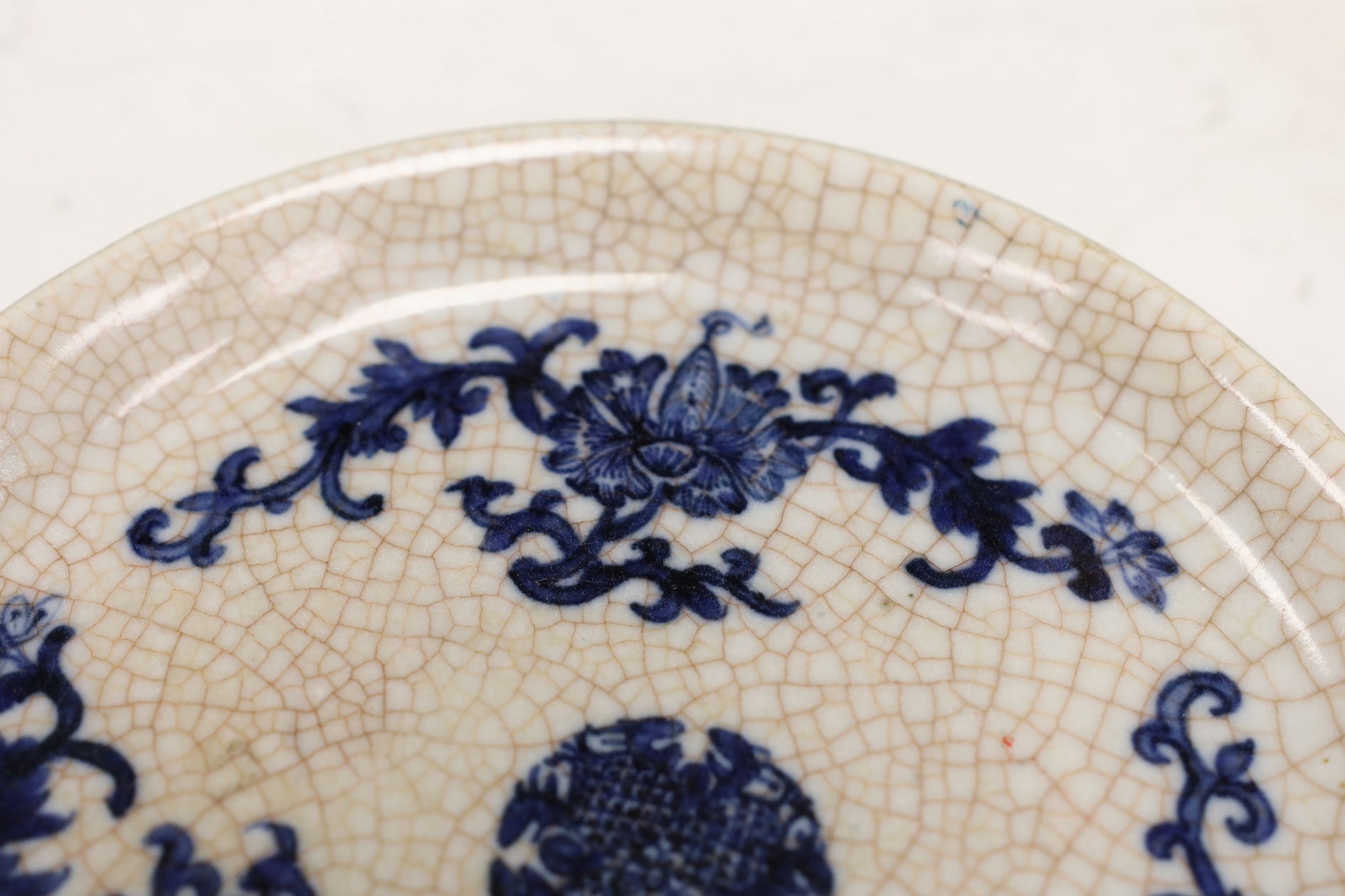 A Chinese crackle glaze chrysanthemum shaped dish, two cups and an underglaze blue dish, 19th century and later, blue dish 21cm diameter (4). Condition - fair